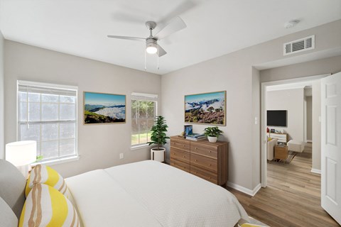 a bedroom with a bed and a ceiling fan